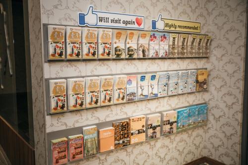 a wall with several shelves filled with toy items at Muzik Hotel - Ximending Xining Branch in Taipei