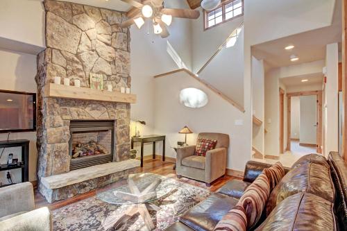 a living room with a large stone fireplace at 6509 Settlers Creek Townhomes in Keystone