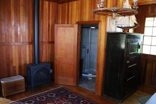 a room with a fireplace and a stove in a room at Aaron's on the Lake in Matlock