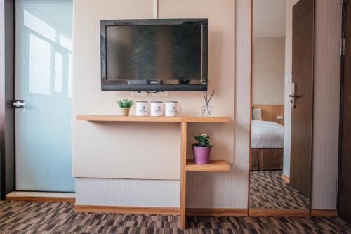 a room with a flat screen tv on a wall at Muzik Hotel - Ximending Xining Branch in Taipei