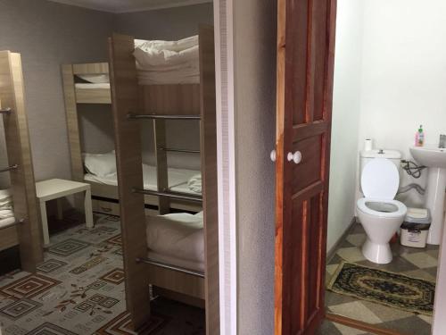 a room with a bathroom with a toilet and a sink at Comfort Guest House in Borovoye