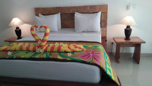 ein Schlafzimmer mit einem Bett mit einer Brezel drauf in der Unterkunft Ocean Resort Amed in Amed