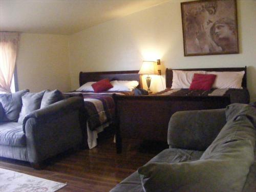 a living room with a bed and a couch and a couch and a chair at 78 Montague in Digby