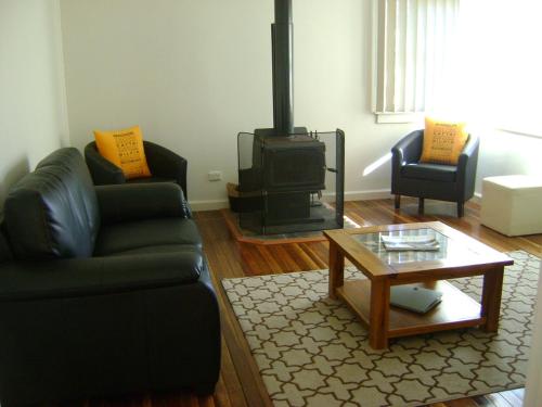 a living room with a couch and a stove at King Cottage in Windsor