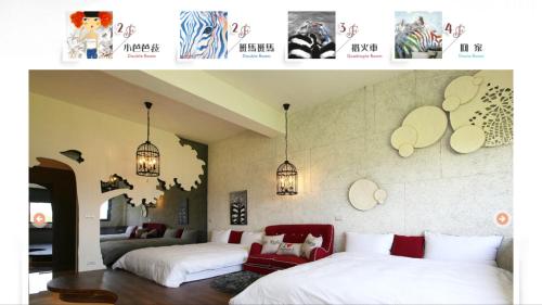 two beds in a room with posters on the wall at Zebra Babala B&B in Dongshan
