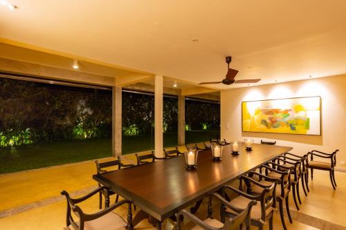 a large dining room with a long table and chairs at Taru Villas The Long House - Bentota in Bentota