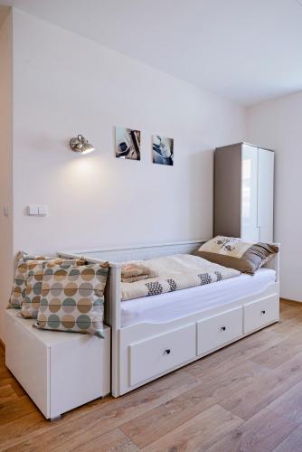 a large white bed in a white bedroom at Slovanský penzion in Mikulčice