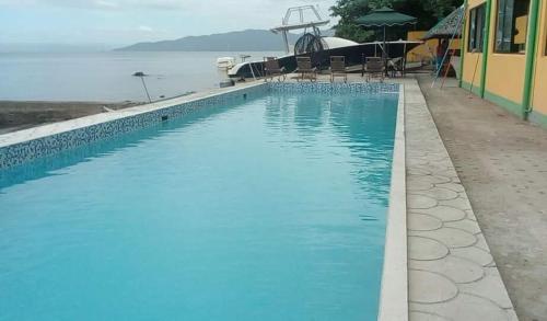 a swimming pool with a view of the water at Meaco Hotel - Anilao in Mabini
