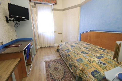 a hotel room with a bed and a television at Hotel Lido in Milan