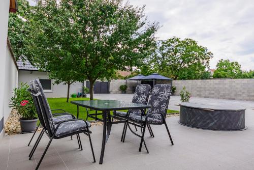 a table and chairs with an umbrella on a patio at Slovanský penzion in Mikulčice