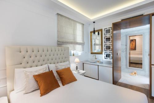 a bedroom with a white bed and a bathroom at La Canea Canvas 1 in Chania