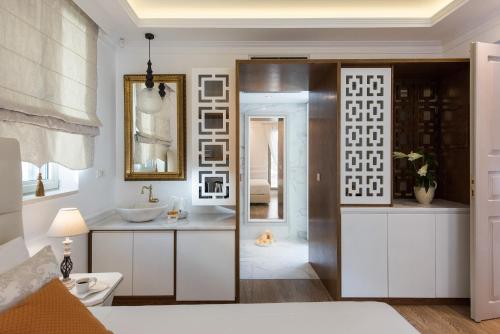 a bathroom with a sink and a mirror at La Canea Canvas 1 in Chania