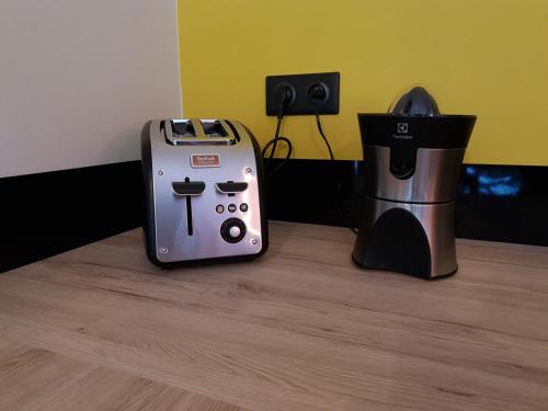 a toaster and a coffee maker sitting on a table at CasaCosy in Les Michels