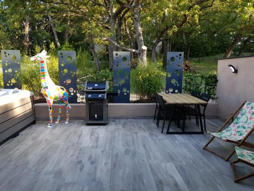 a toy giraffe standing on a patio with a table at CasaCosy in Les Michels