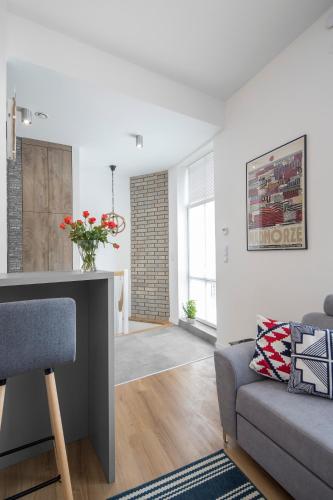 a living room with a couch and a table at Apartamenty4you - Apartamenty Atlantic in Sopot