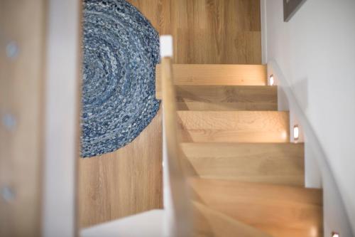 a view of a staircase with a blue rug at Apartamenty4you - Apartamenty Atlantic in Sopot