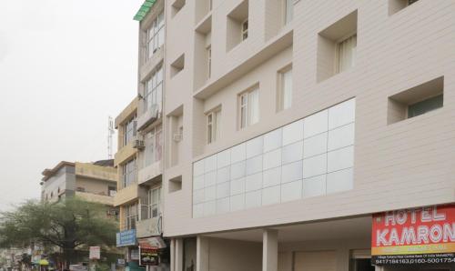 a tall white building on a city street at Itsy By Treebo - Kamron in Chandīgarh