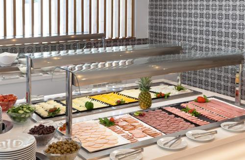a buffet line with different types of food at The Blue Ivy Hotel & Suites in Protaras
