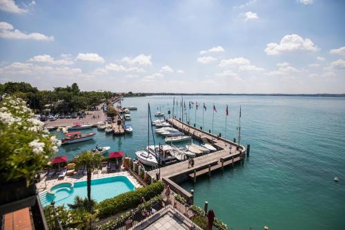 a view of a marina with boats in the water at Hotel Sirmione Terme in Sirmione