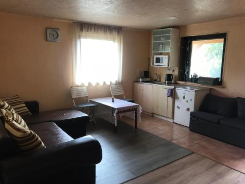 a living room with a couch and a table at Anykščių raj. Žalioji Stotelė in Šventupys