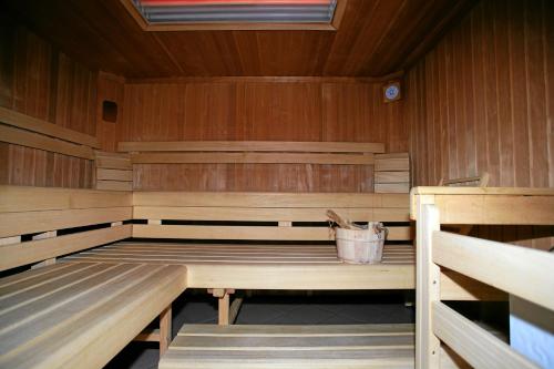 a wooden sauna with a bucket in it at APART Kirschner in Sankt Leonhard im Pitztal