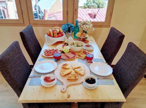 a wooden table with food on it with chairs at Old Town Mtatsminda in Tbilisi City
