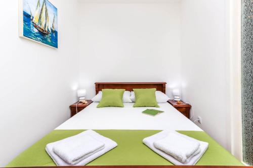 a bedroom with a large white bed with two pillows at Apartment Little Paradise - In the city center in Tivat