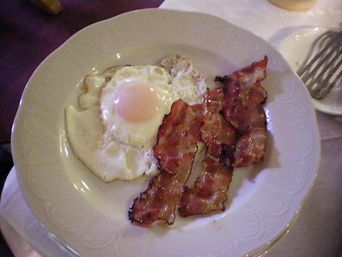 a plate of food with eggs and bacon on it at Gasthof Geierwallihof Klotz Konrad KEG in Vent