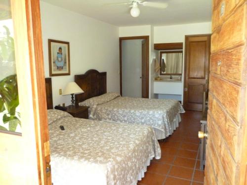 Ein Bett oder Betten in einem Zimmer der Unterkunft Hotel Hacienda