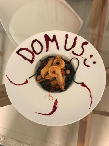 a plate of food with the word soups on it at Domus Hotel & Apartments in Shëngjin