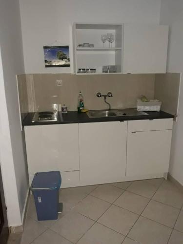 a kitchen with a sink and a counter top at Apartments Pag Holiday in Pag