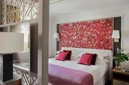 a bedroom with a large bed with pink pillows at VISTA Lago di Como in Como