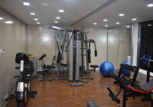 a gym with a bunch of machines in a room at Sayaji Vadodara in Vadodara