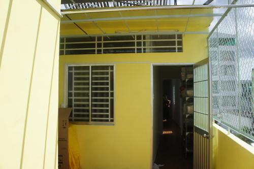 a view from the outside of a house with a balcony at BangBang Motel in Can Tho