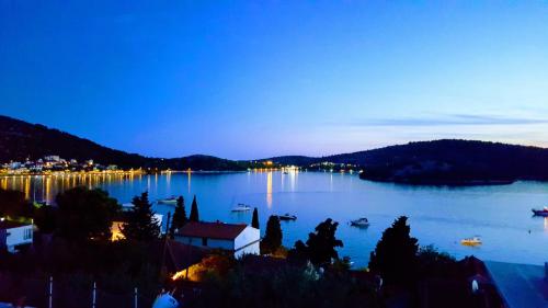 a view of a large lake at night at Apartments Maria in Tisno