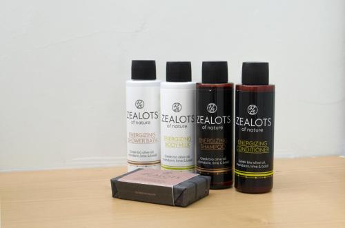 a group of four bottles of hair products on a table at Thea Suites in Nea Kalikratia