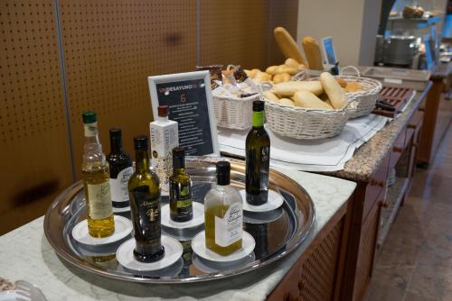 a tray of bottles of wine and bread on a counter at Parador de Cordoba in Córdoba