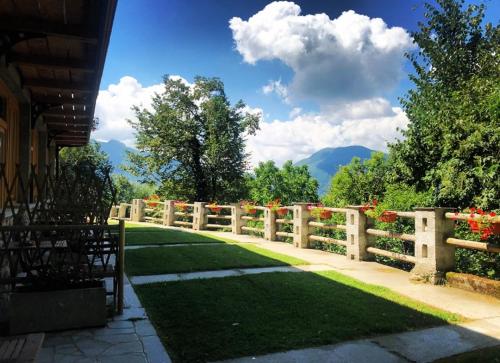 a wooden fence with flowers on it in a yard at Agriturismo La Selvaggia in Mandello del Lario