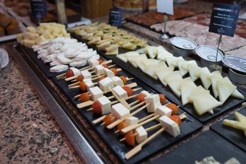 a bunch of different types of cheese on a table at Parador de Cordoba in Córdoba