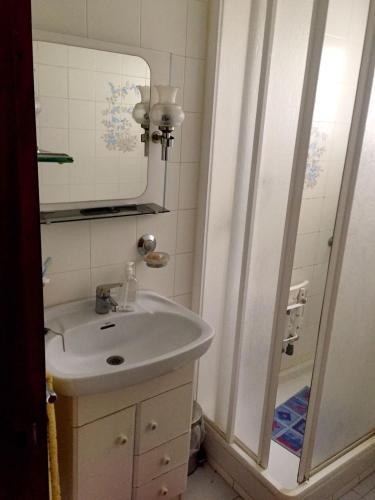 a bathroom with a sink and a mirror and a shower at Apartamento centrico castillo s. Barbara in Alicante