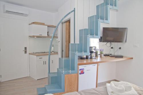 a blue staircase in a room with a kitchen at Christina Beach Hotel in Chania Town
