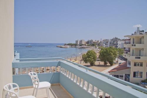 a balcony with two chairs and a view of the beach at Christina Beach Hotel in Chania Town