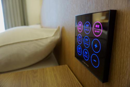a control panel on a wall next to a bed at Ecology River in Dongshan