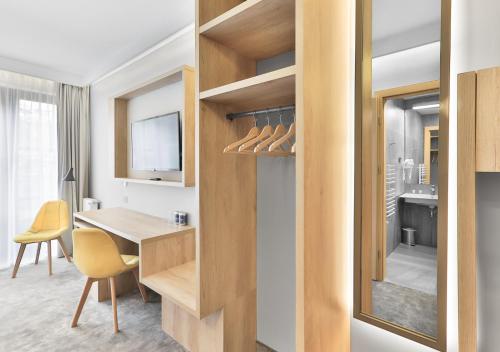 a kitchen and dining room with a table and yellow chairs at Villa Ozone in Sopot