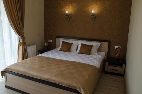 a bedroom with a large bed with two pillows at Triumph in Skhidnitsa