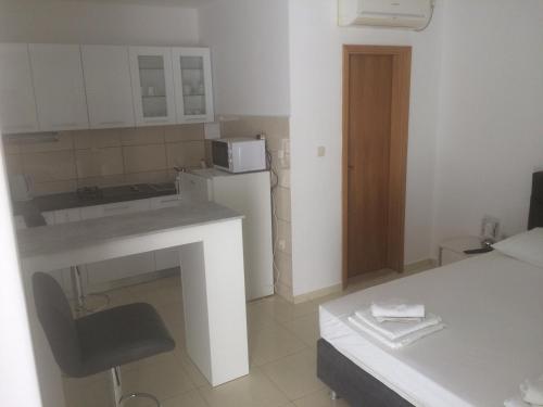 a small kitchen with a sink and a microwave at Apartments Elvira in Sveta Nedelja