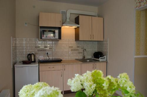 a kitchen with wooden cabinets and a white refrigerator at Triumph in Skhidnitsa