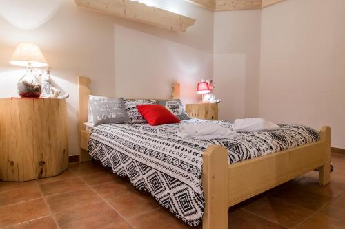 a bedroom with a bed with a black and white comforter at Chaty Zakopane in Zakopane