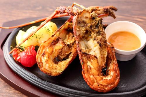 a plate of food with shrimp and a dipping sauce at Osaka Tokyu REI Hotel in Osaka