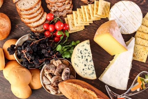 a table topped with different types of cheese and bread at Osaka Tokyu REI Hotel in Osaka
